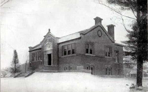 Black and white image depicting the front and side exterior of the Tipton Public Library. Taken from the 1st Report of the Iowa Library Commission, coverage 1900-1903. (Published in 1904), opposite page 126.