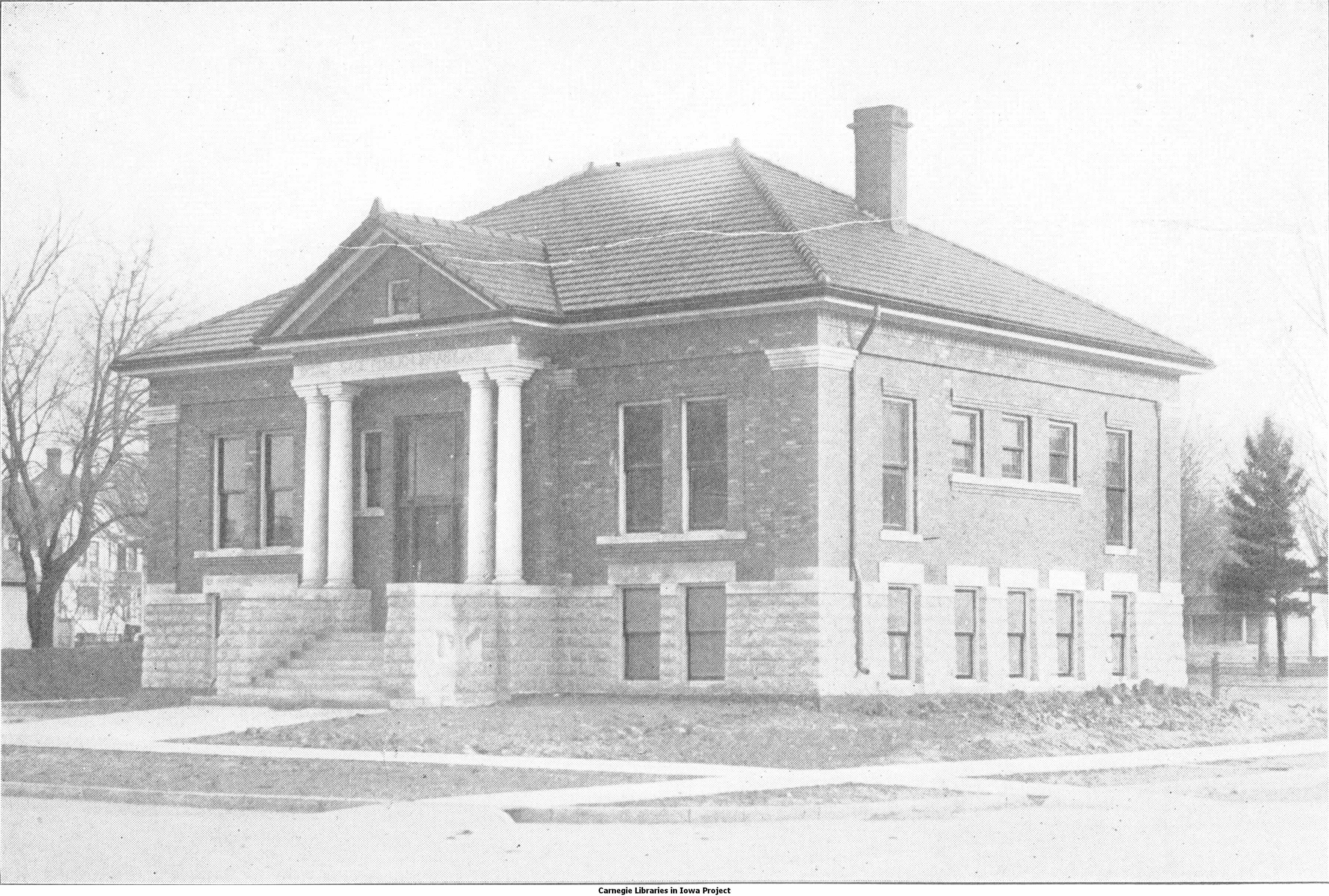 Black and white image showing the front exterior of the Osage Public Library. Taken from the 6th Report of the Iowa Library Commission, coverage 1910-1912. (Published in 1913), opposite page 13.