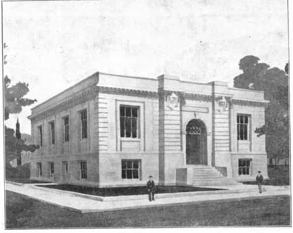 Black and white image showing the exterior of the Perry Public Library and two people standing near the library. 