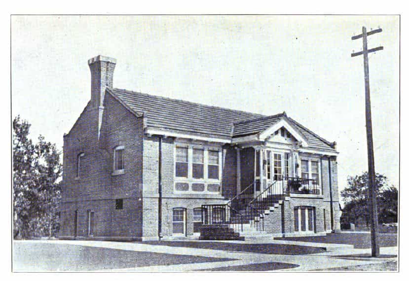 Black and white image depicting the front and side exterior of the Alden Public Library. Taken from the 7th Report of the Iowa Library Commission, coverage 1912-1914. (1914), opposite page 9. 