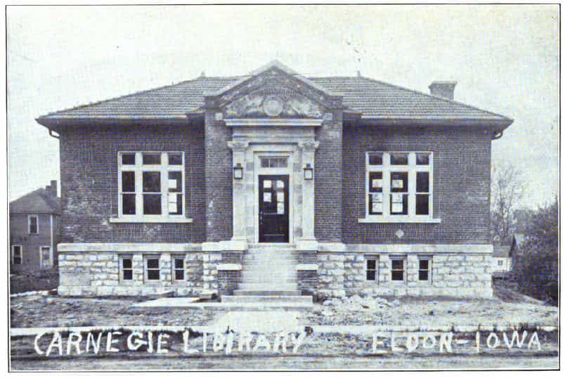 Black and white image showing the exterior of the Eldon Public Library. Text reads "Carnegie Library Eldon-Iowa" Taken from the 7th Report of the Iowa Library Commission, coverage 1912-1914. (Published in 1914), opposite page 17.