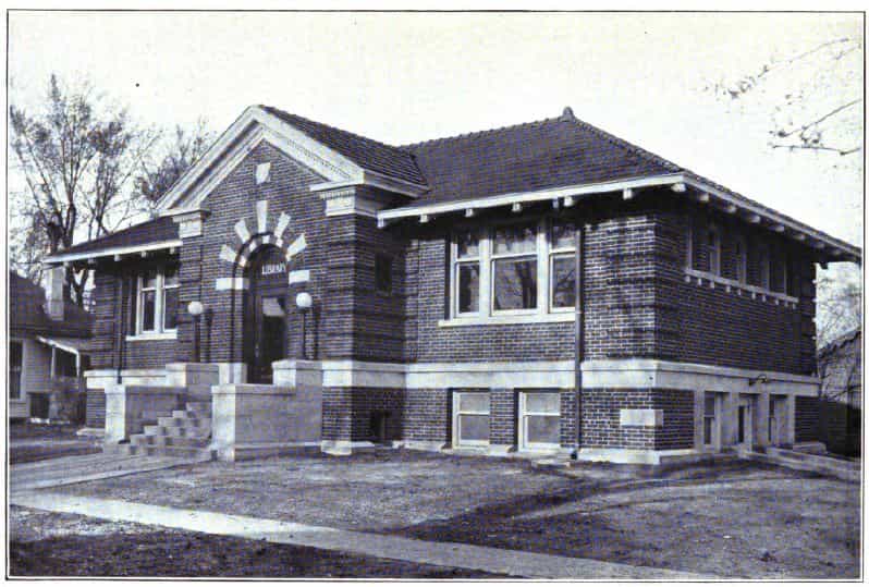 Black and white image showing the front and side exterior of the Sigourney Public Library. Taken from the 7th Report of the Iowa Library Commission, coverage 1912-1914. (Published in 1914), opposite page 11.