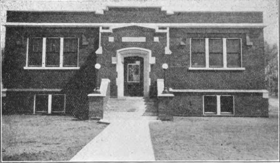 Black and white image showing the front exterior of the Malvern Public Library. Taken from the 9th Report of the Iowa Library Commission, coverage 1916-1918. (Published in 1918), page 7.